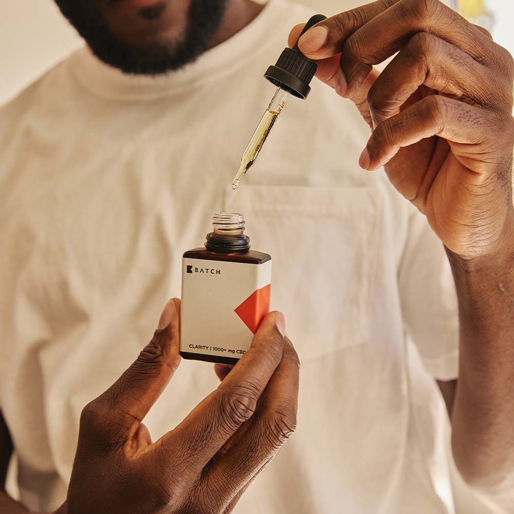 man extracting oil from bottle